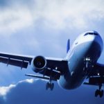 Passenger Airliner overhead with stormy sky